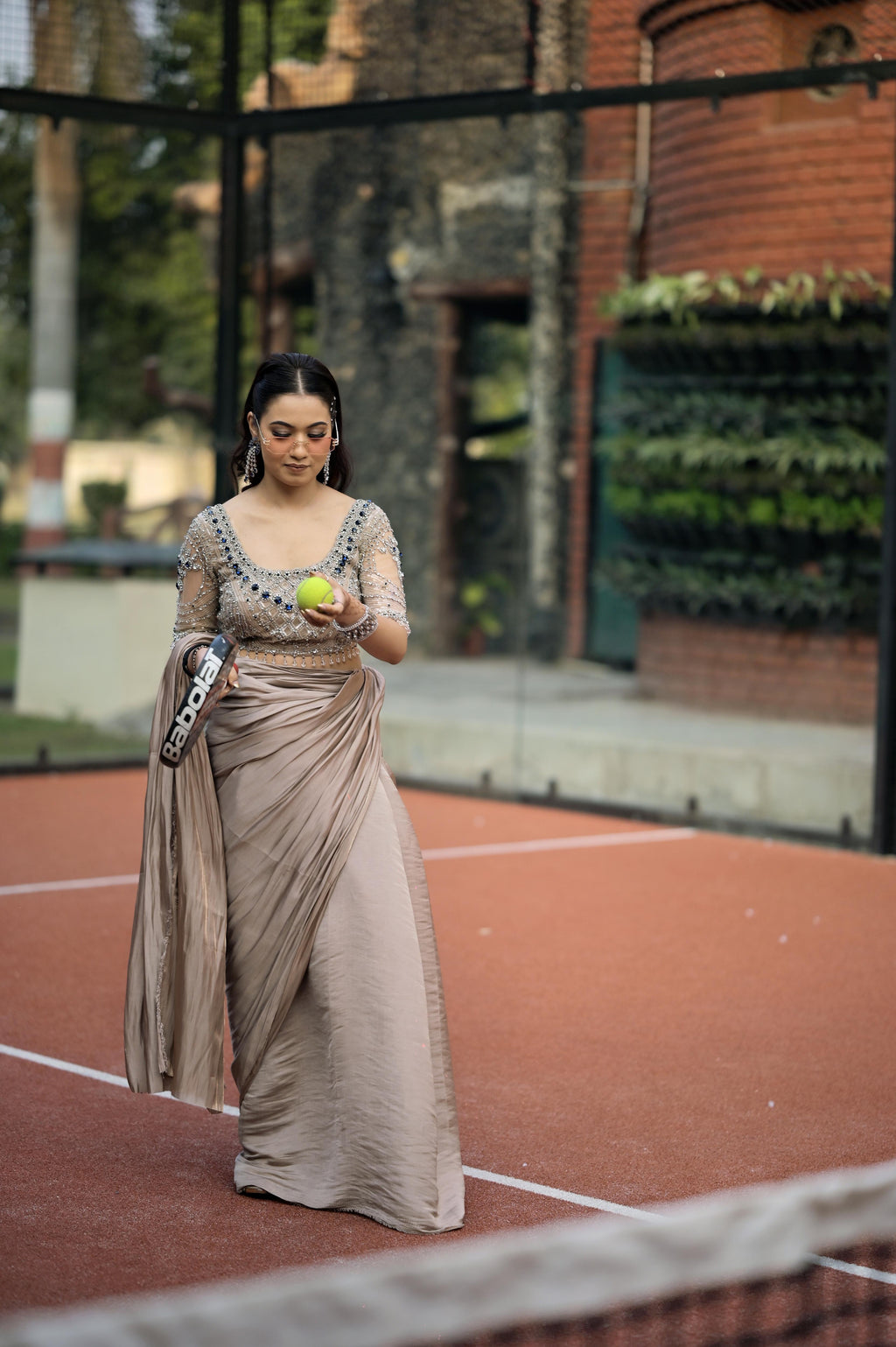 Nude Pink satin draped saree paired with a modern blouse featuring intricate crystal embroidery