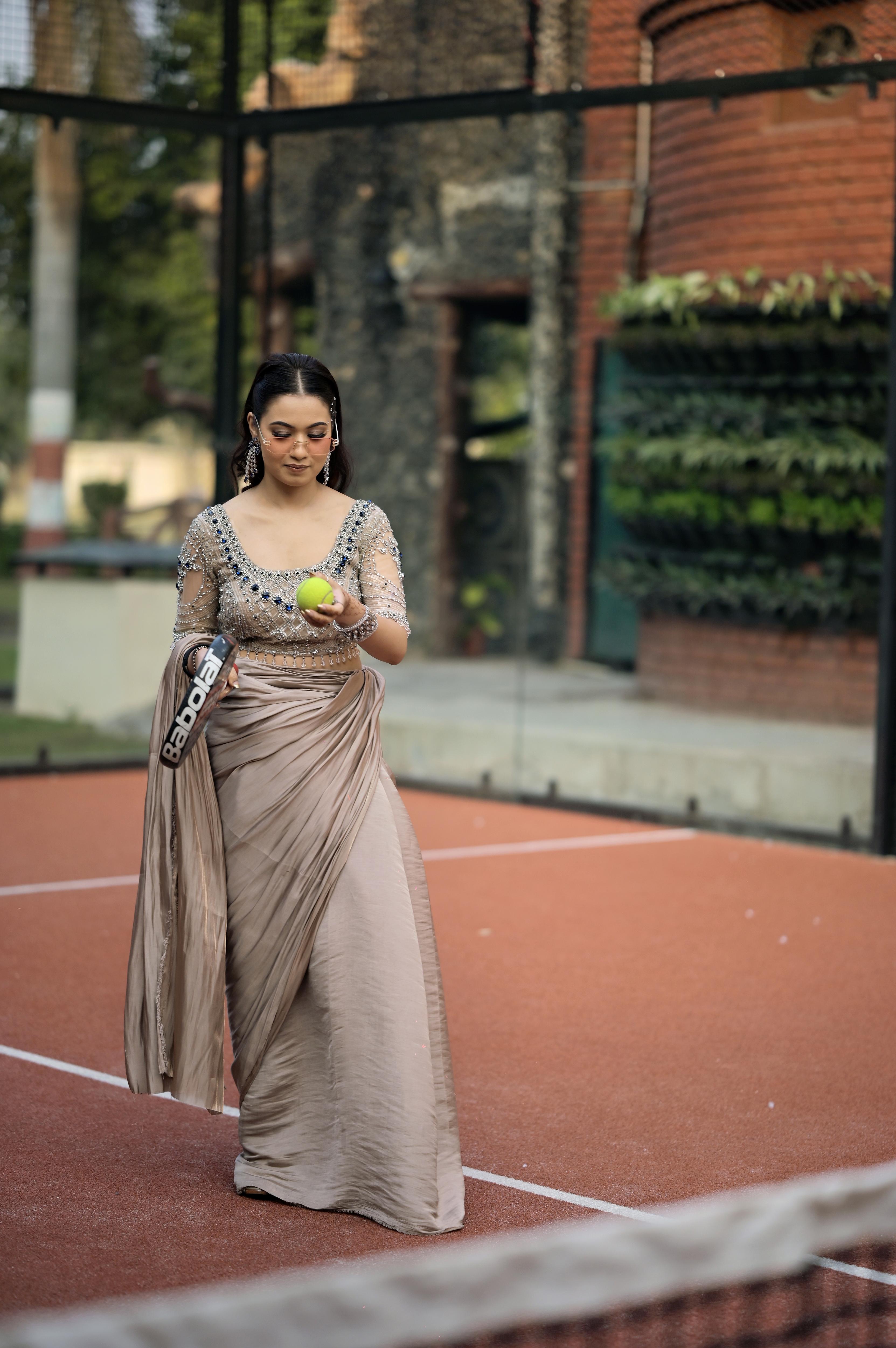 Nude Pink satin draped saree paired with a modern blouse featuring intricate crystal embroidery