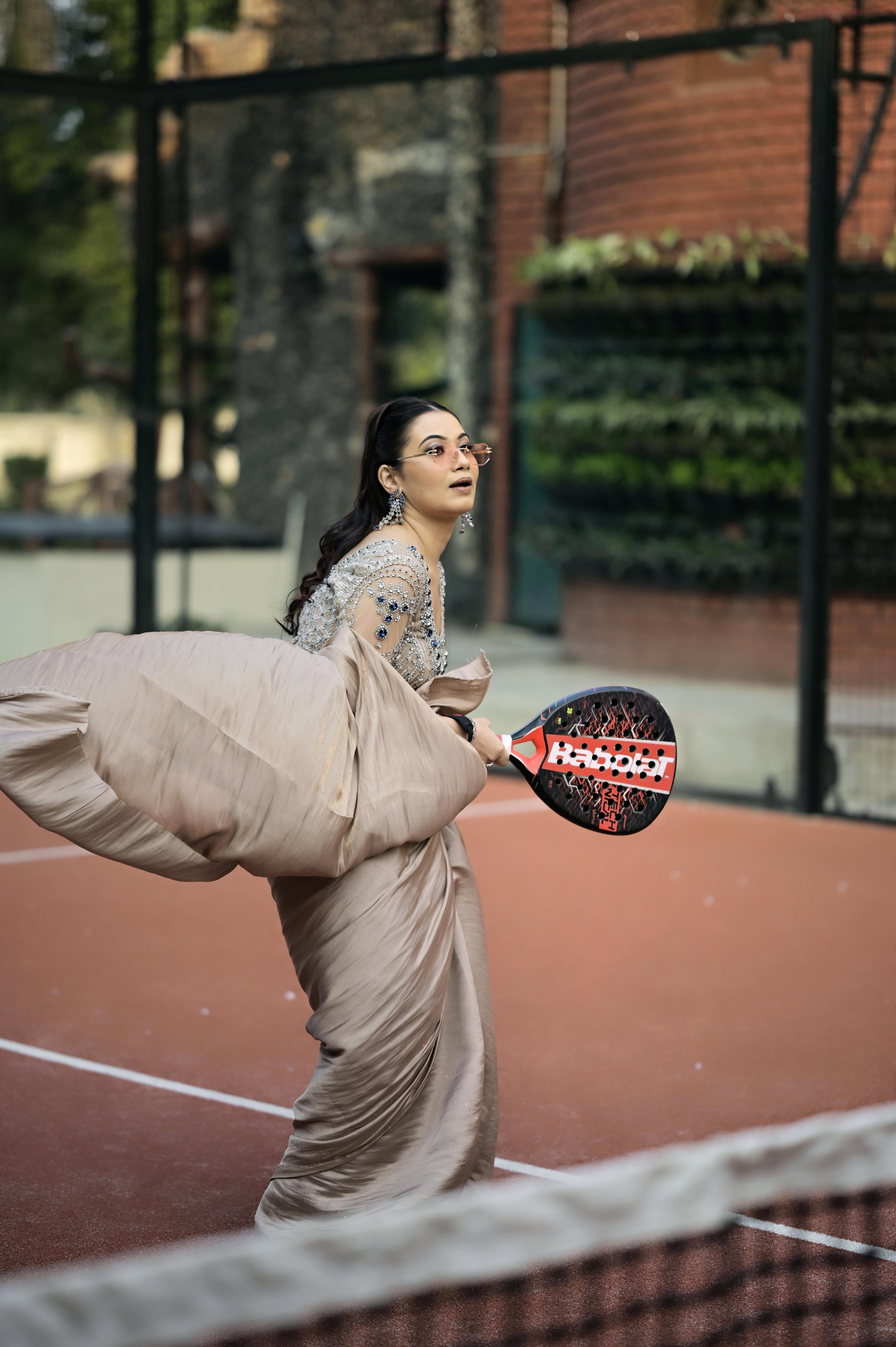 Nude Pink satin draped saree paired with a modern blouse featuring intricate crystal embroidery