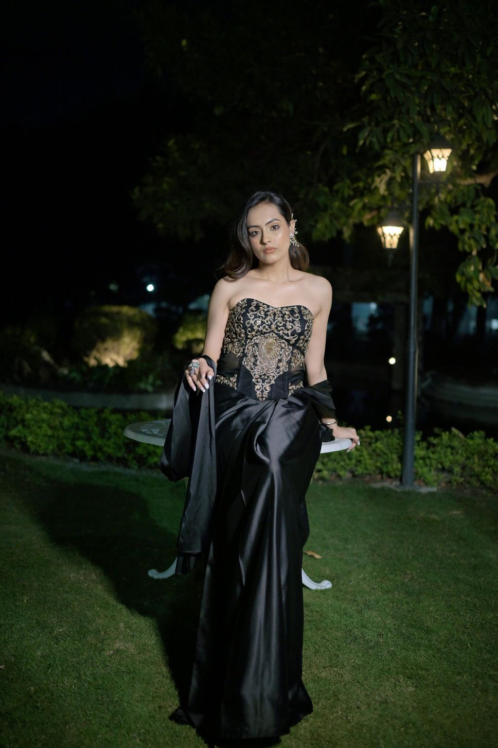 Hand-embroidered corset blouse with intricate detailing, paired with a draped saree