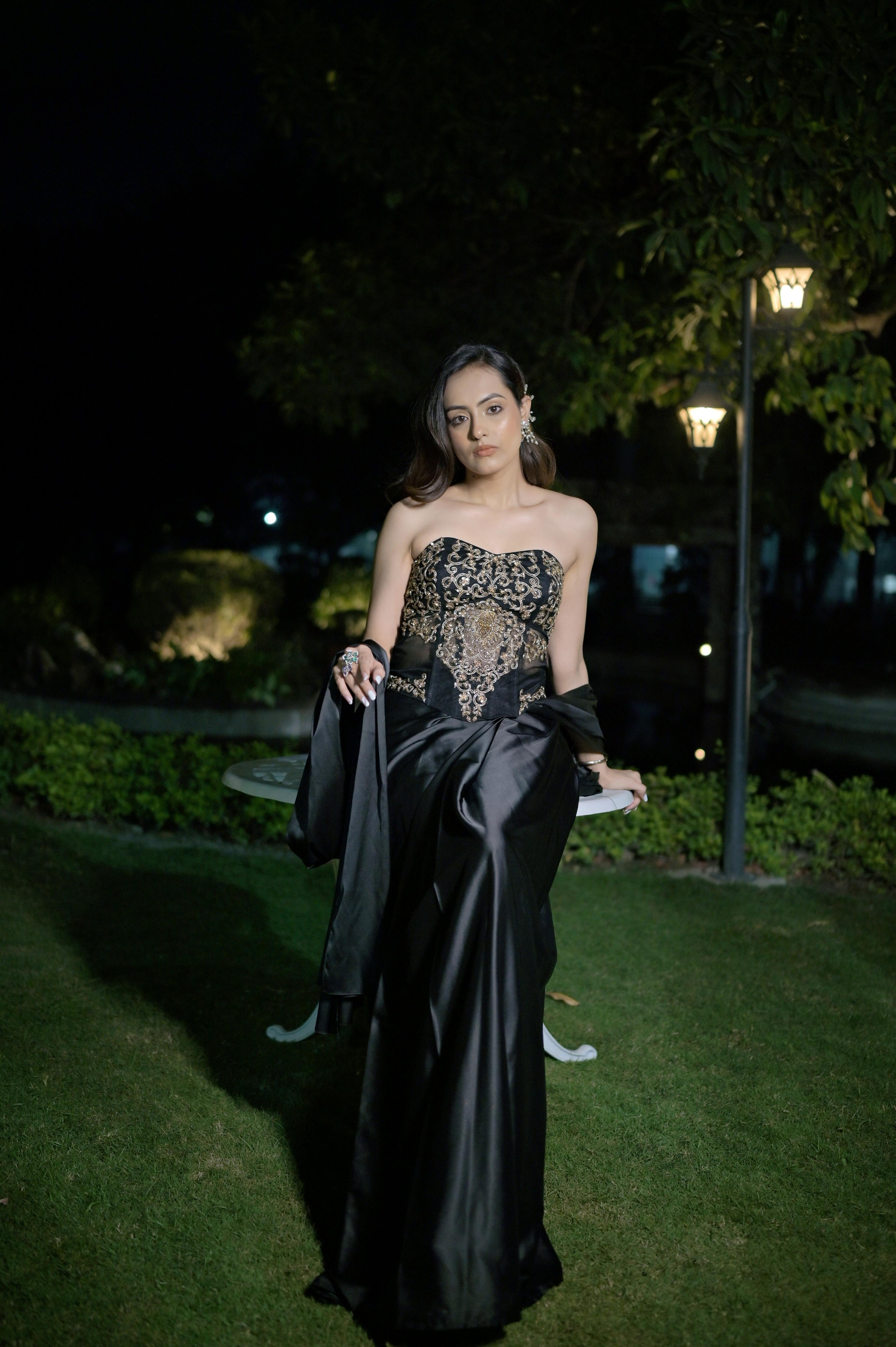 Hand-embroidered corset blouse with intricate detailing, paired with a draped saree