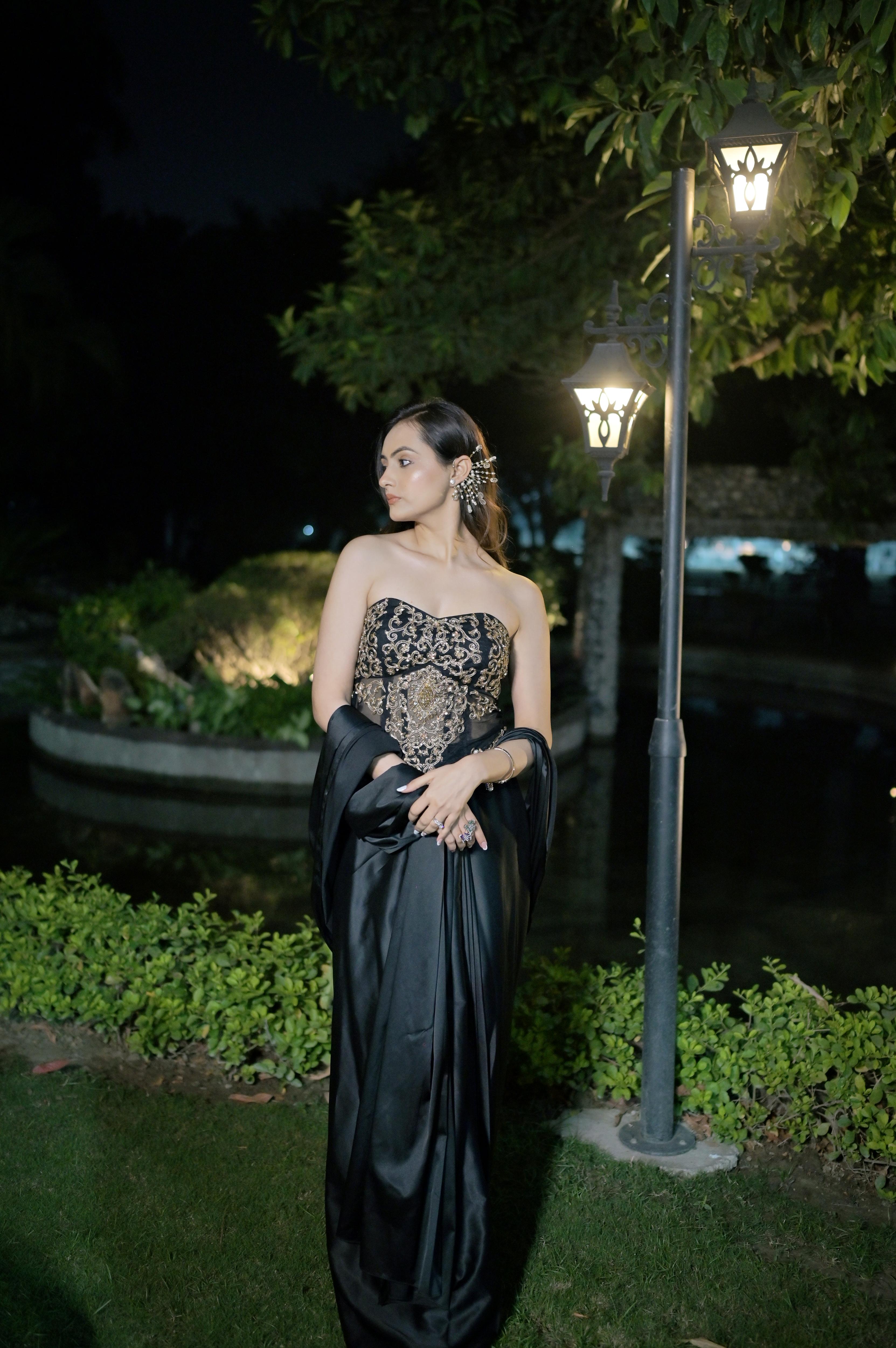 Hand-embroidered corset blouse with intricate detailing, paired with a draped saree